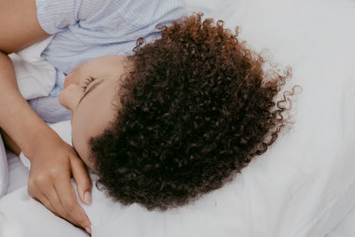 Free A Woman Sleeping on Her Side Stock Photo