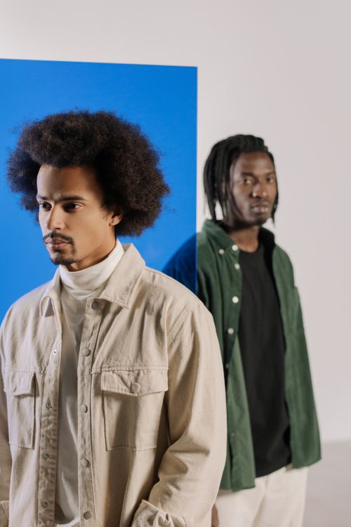 Free Modern studio portrait of stylish men with afro hair and dreadlocks in fashionable attire. Stock Photo