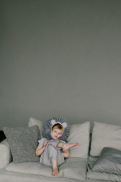A Kid with a Costume Sitting on the Couch