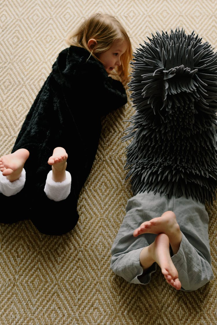 Children In Animal Costume Lying On The Floor