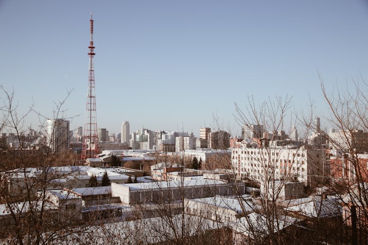 Modern Buildings And Transmission Tower In City