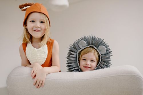 Free Two children in animal costumes happily posing indoors, showcasing playful innocence and joy. Stock Photo