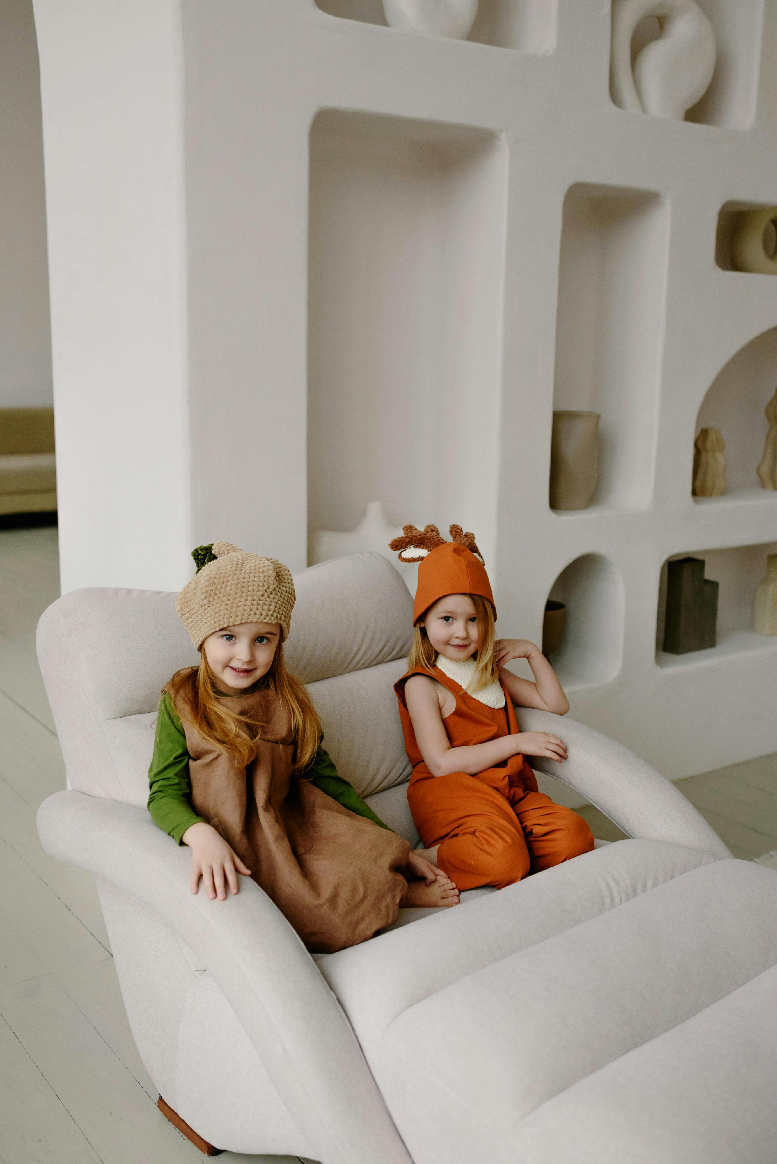 girls in costume sitting on a chair