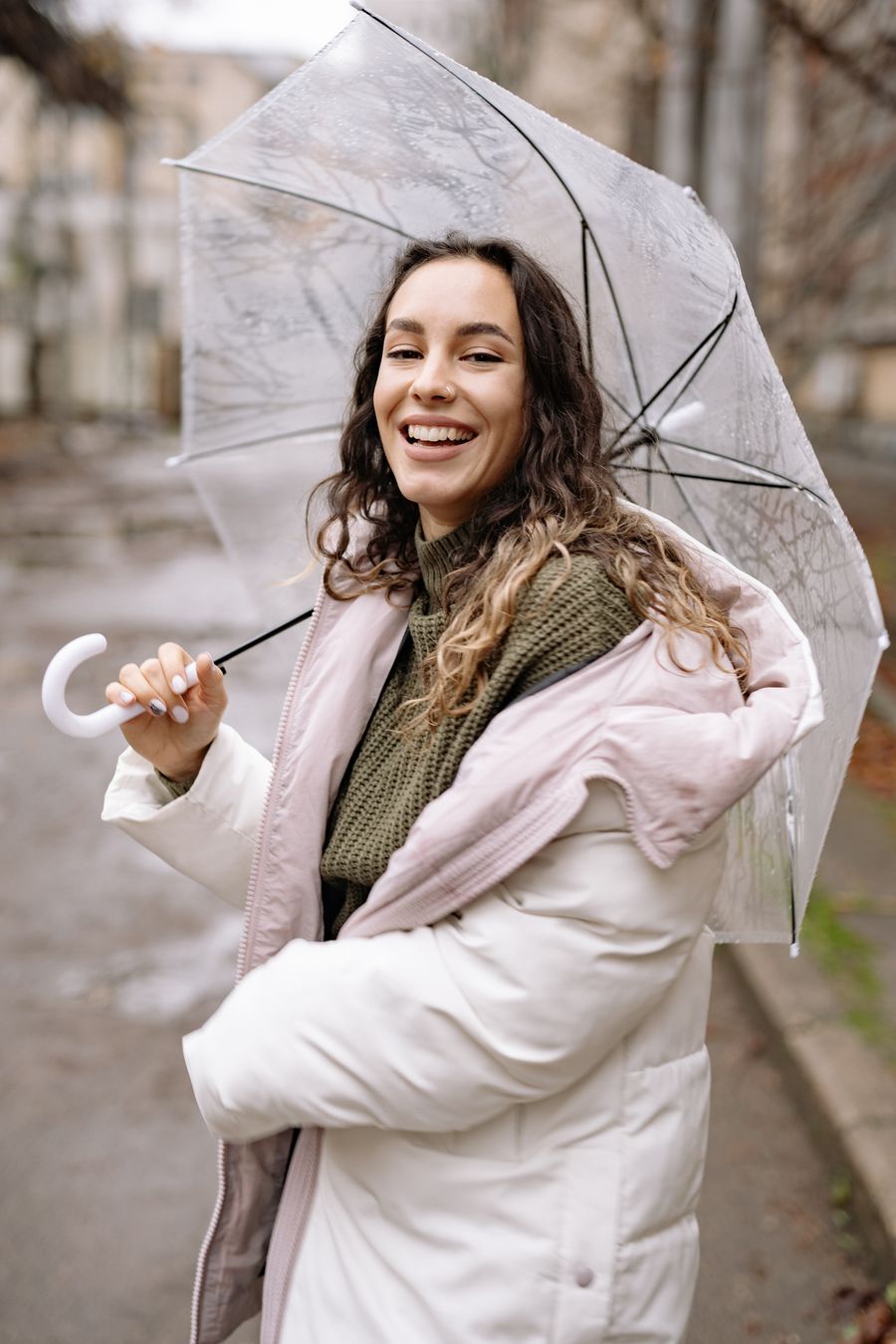 Model in a sage cape looking upward in the rain — photo by Yan Krukau on Pexels