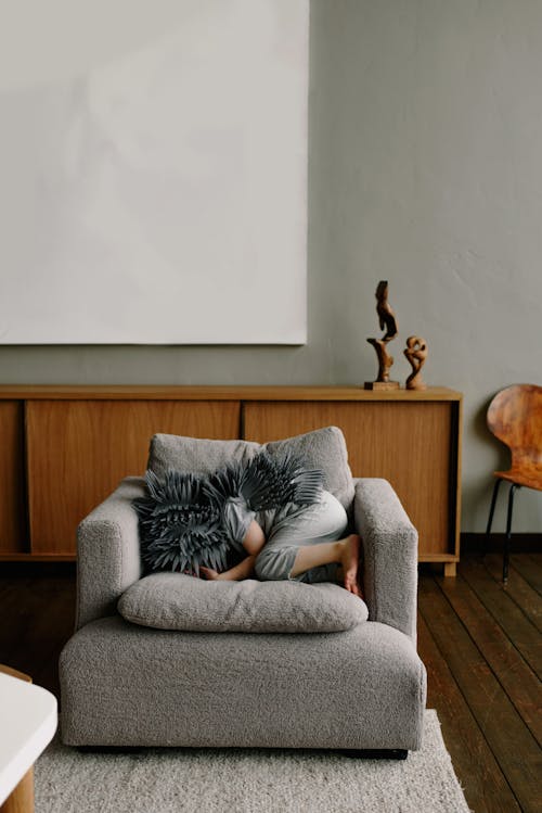 Free A Child Wearing a Costume Hiding on the Couch Stock Photo