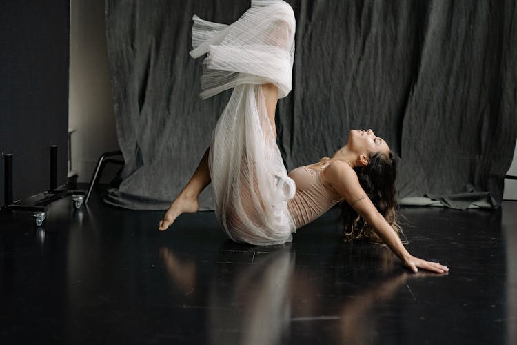 Studio Portrait Of Woman With Legs In The Air