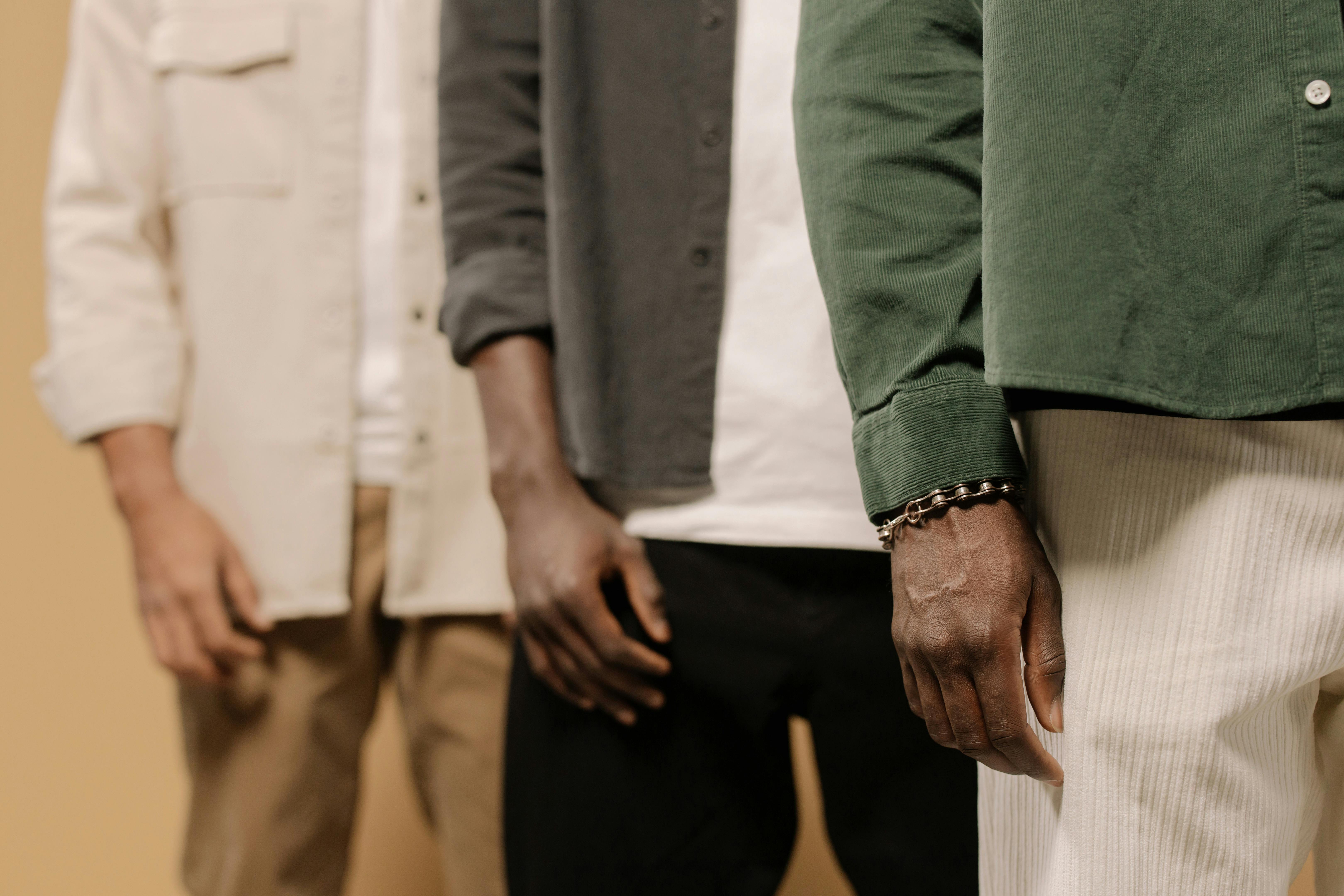 Stylish men's fashion shoot showcasing casual shirts and pants in neutral tones.