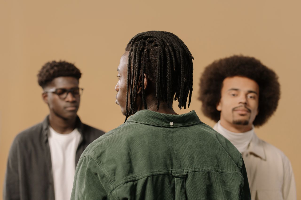 portrait of three stylish men with diverse hairstyles in a studio sett