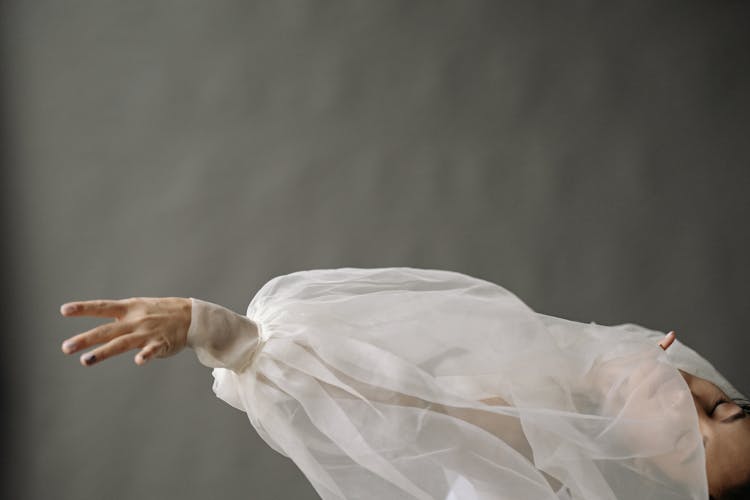 Extended Arm Of A Woman In White Chiffon Long Sleeves 