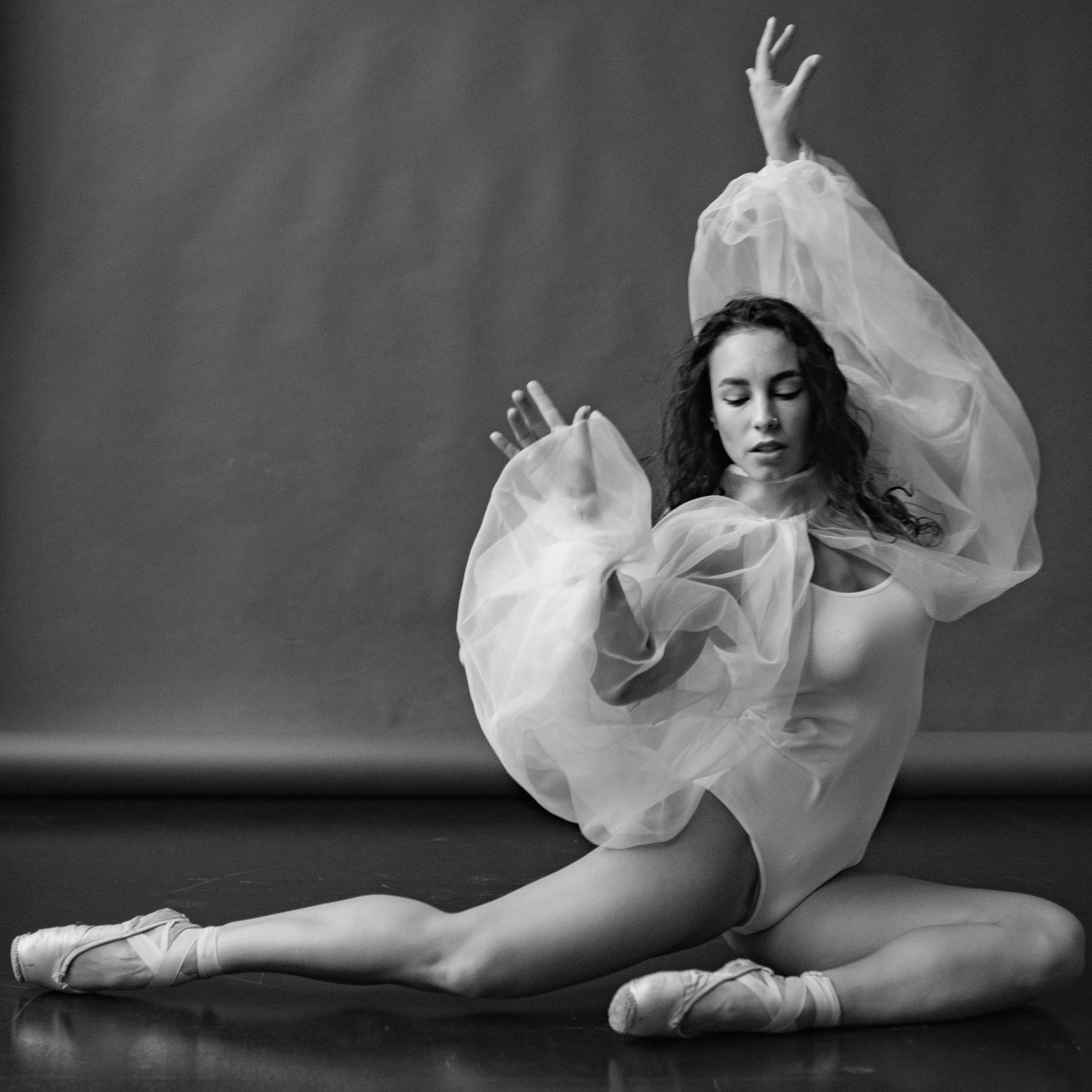 A Ballet Dancer Sitting and Posing on the Floor