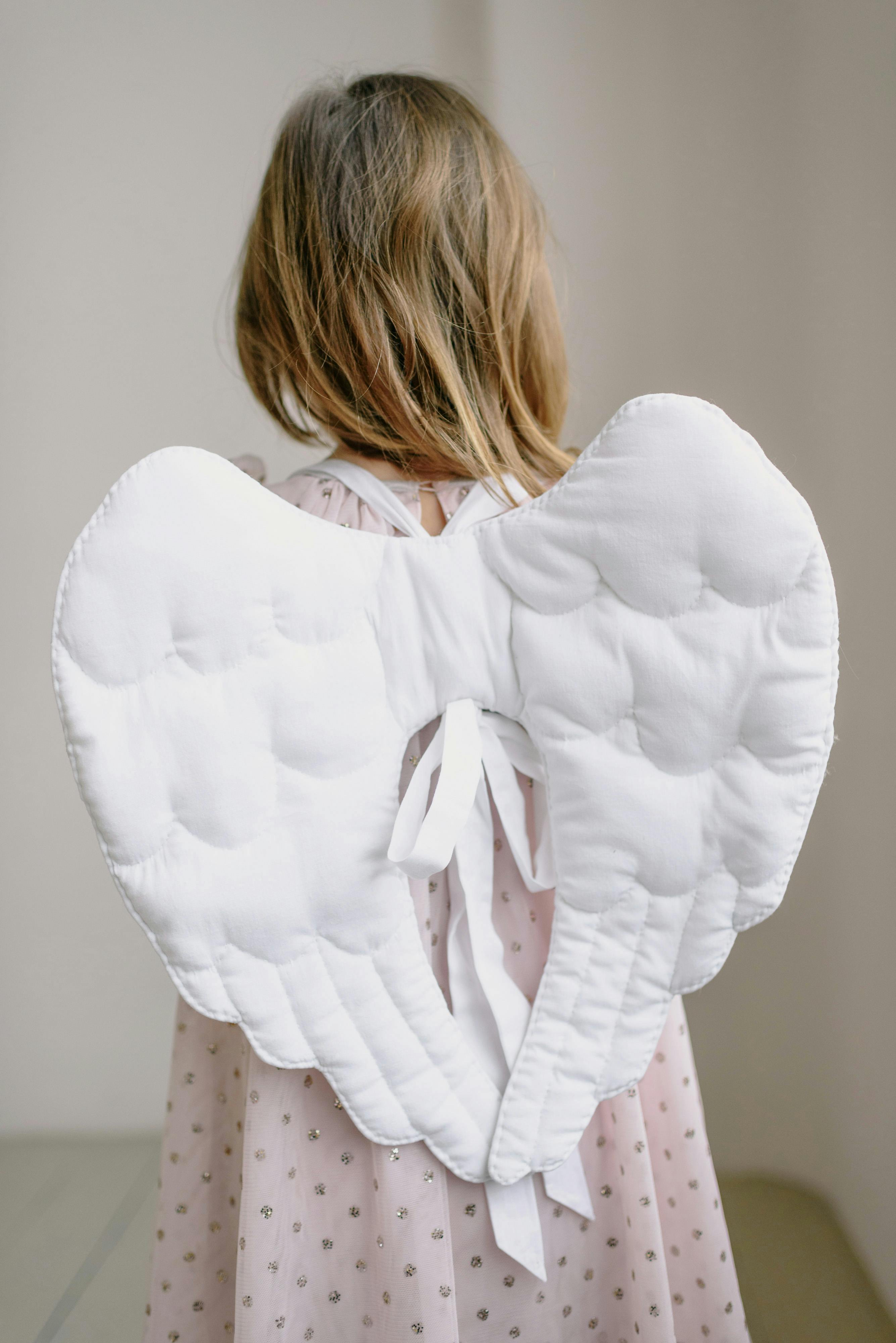 a girl in white angel costume