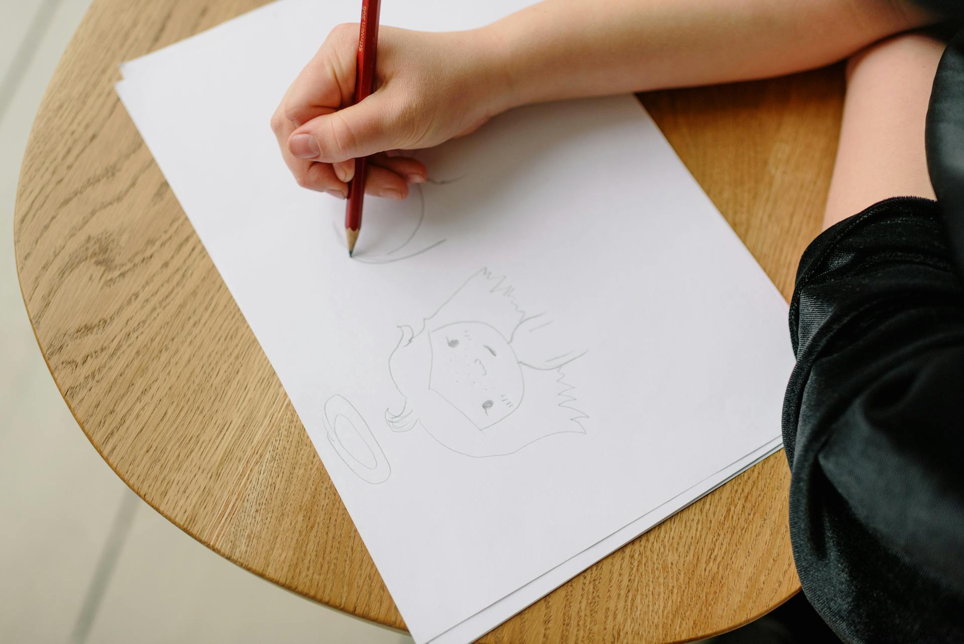 A Person Drawing on a Bond Paper