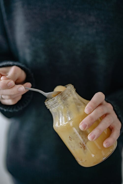 Free Person Holding Glass Jar with Honey  Stock Photo