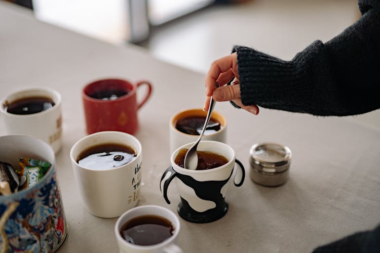 Woman Stirring Tea In A Cup