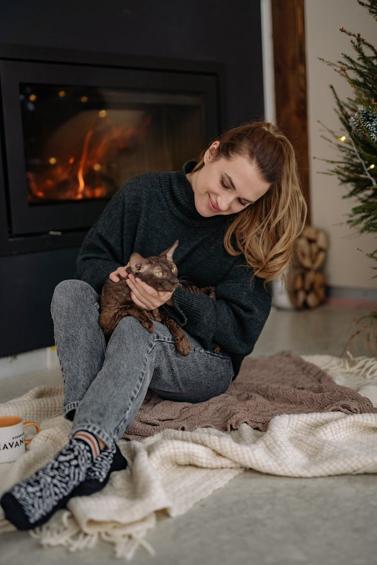 A Woman Holding A Cat