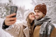 A Snow Covered Couple Taking a Selfie