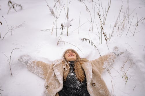 Free Woman in Fur Coat laying On Snow Stock Photo