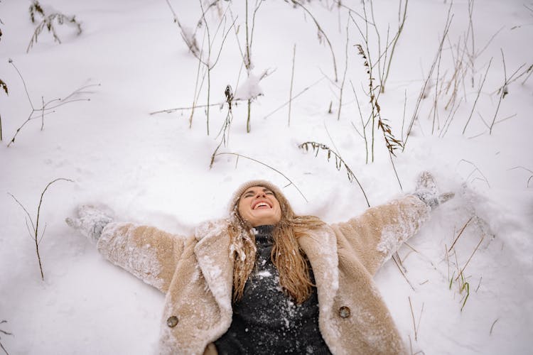 Woman In Fur Coat Laying On Snow