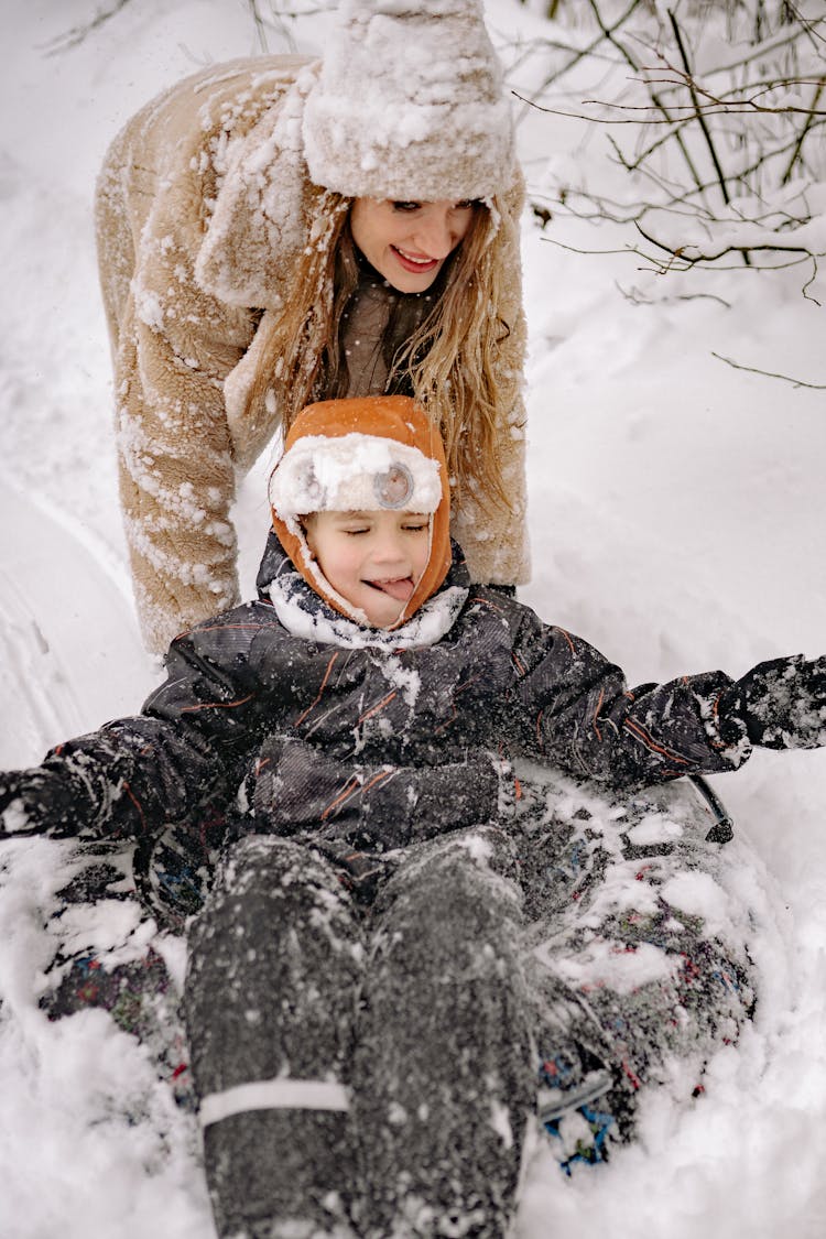 A Mother And Child Having Fun Playing In The Snow