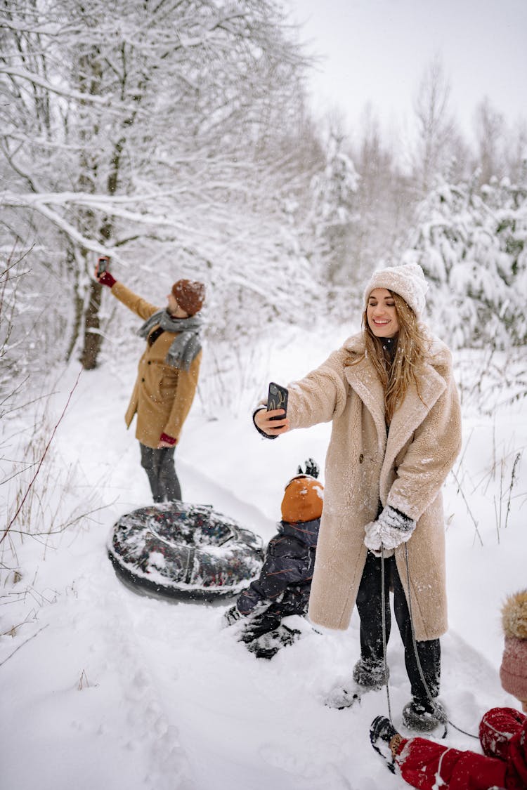 Family Sledding With Their Kids 