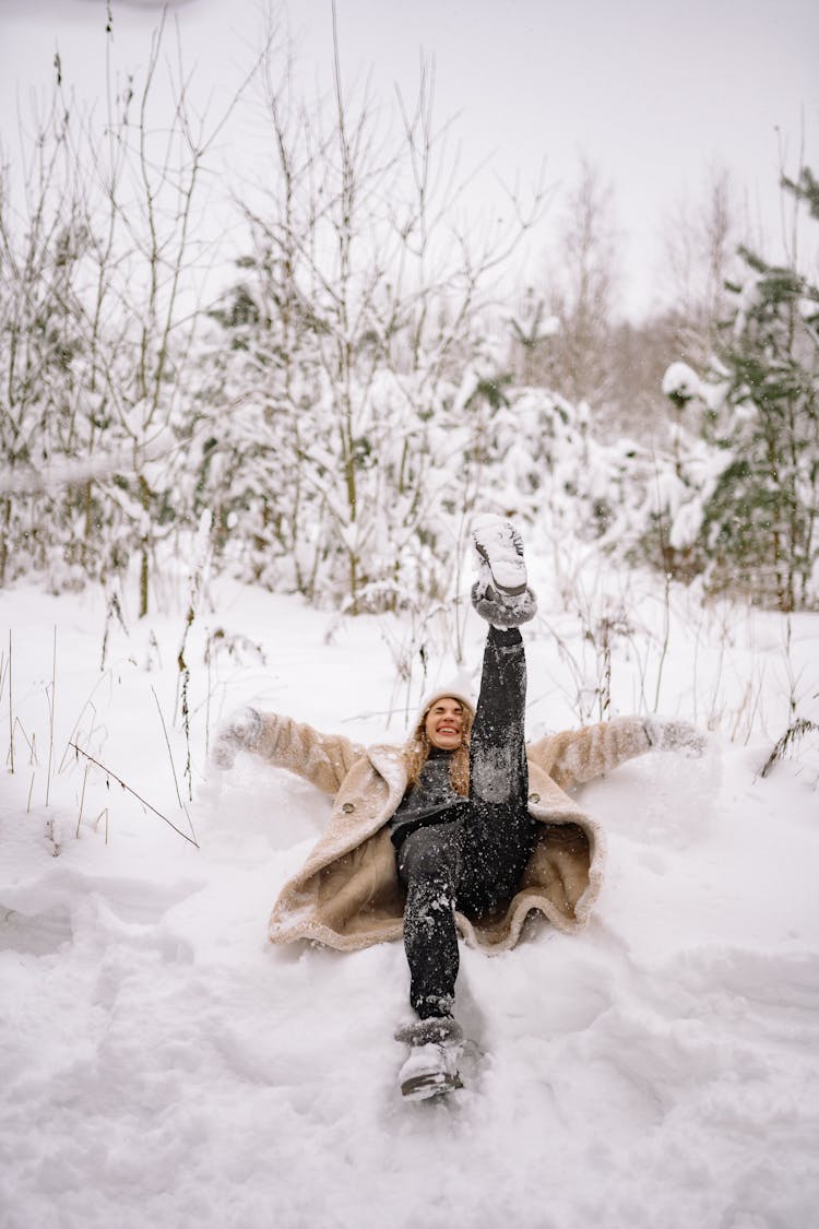 Woman In Fur Coat Laying On Snow