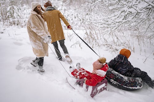 Couple Taking Their Children Sledding