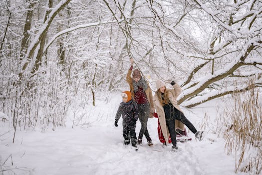 Family enjoys a winter walk in a snow-covered forest, surrounded by icy beauty.