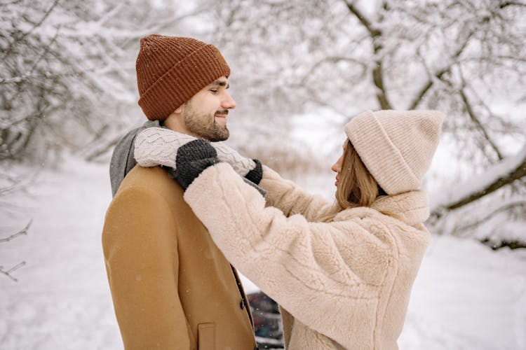 Shallow Focus Photo Of A Lovely Couple In Winter Clothes Looking At Each Other