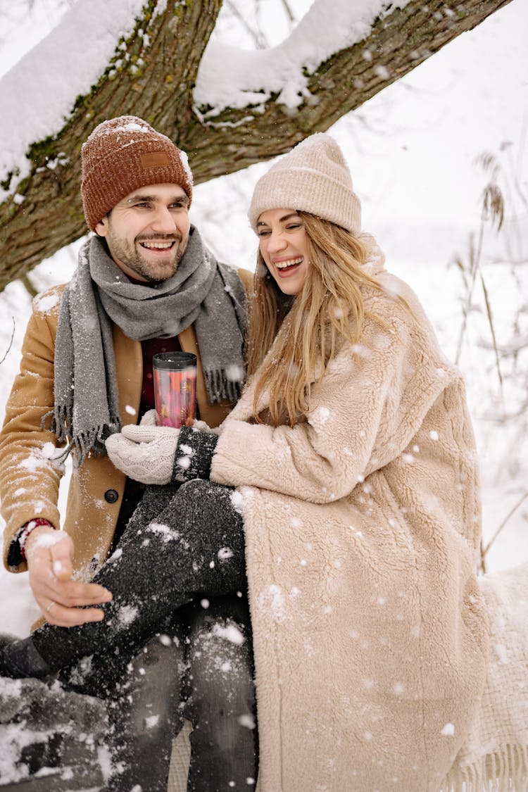 A Lovely Couple In Winter Clothes Having Fun During Winter