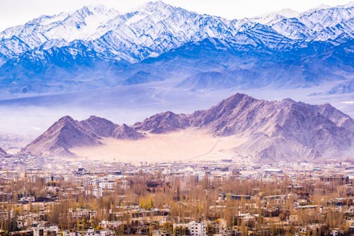 Aerial View of City at Foot of Mountain Range