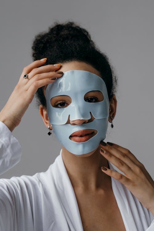 Free Woman with Black Curly Hair Wearing a Facial Mask Stock Photo