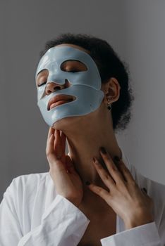 Serene portrait of woman enjoying a hydrating facial mask for skincare routine.