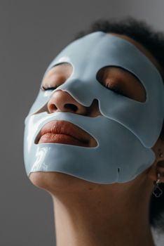 Close-up of a woman enjoying a hydrating face mask, emphasizing relaxation and skincare.