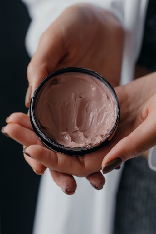 Close-Up Photo of a Person Holding a Skin Care Product