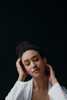 Portrait of a young woman with a skincare mask on, enjoying self-care and relaxation.