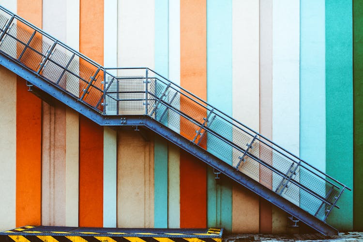 Blue Metal Staircase And Striped Wall