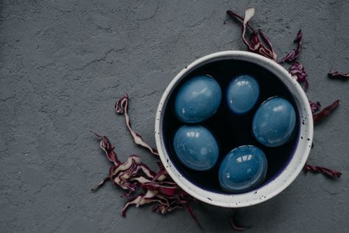 Free Beautifully dyed blue Easter eggs in a bowl using red cabbage on a textured background. Stock Photo