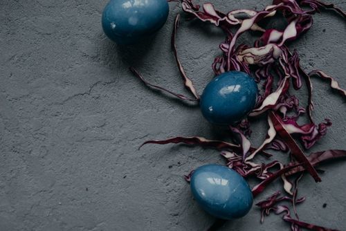 Free Artistic photo of blue Easter eggs dyed with red cabbage on a textured concrete surface. Stock Photo