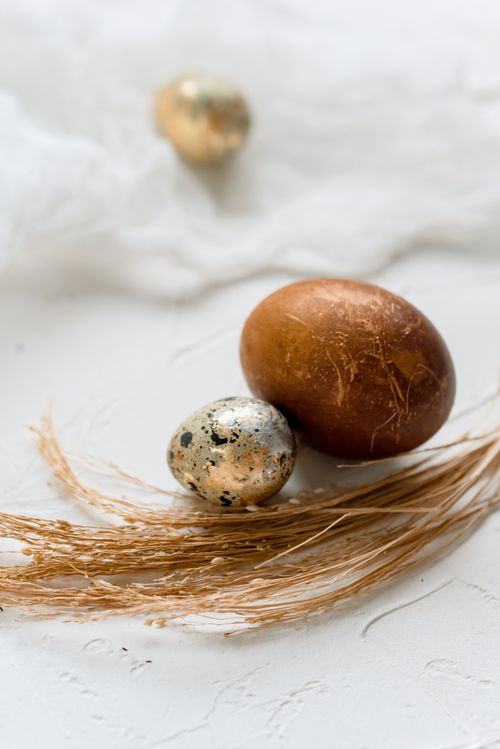 Free Elegant Easter-themed setup with painted quail egg and decorative elements on rustic surface. Stock Photo