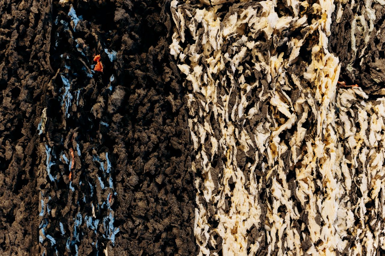 close up of a textured surface with dark and light multicolored layers