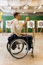 Boy in White Hoodie Riding on Black and Gray Wheel Chair