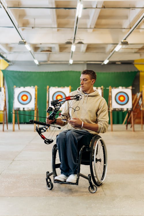 Woman in a Wheel Chair Holding a Bow