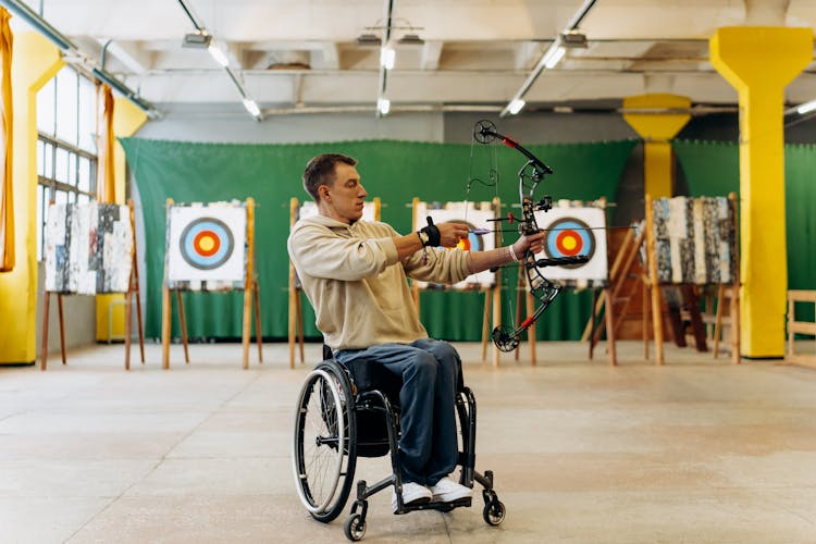 A Man Holding A Bow And Arrow 