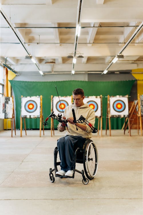 Man with a Wheelchair Preparing His Bow and Arrow