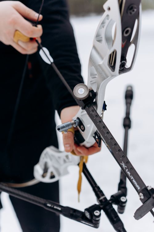 Free Close-up of an archer handling bow and arrows in a snowy landscape. Stock Photo