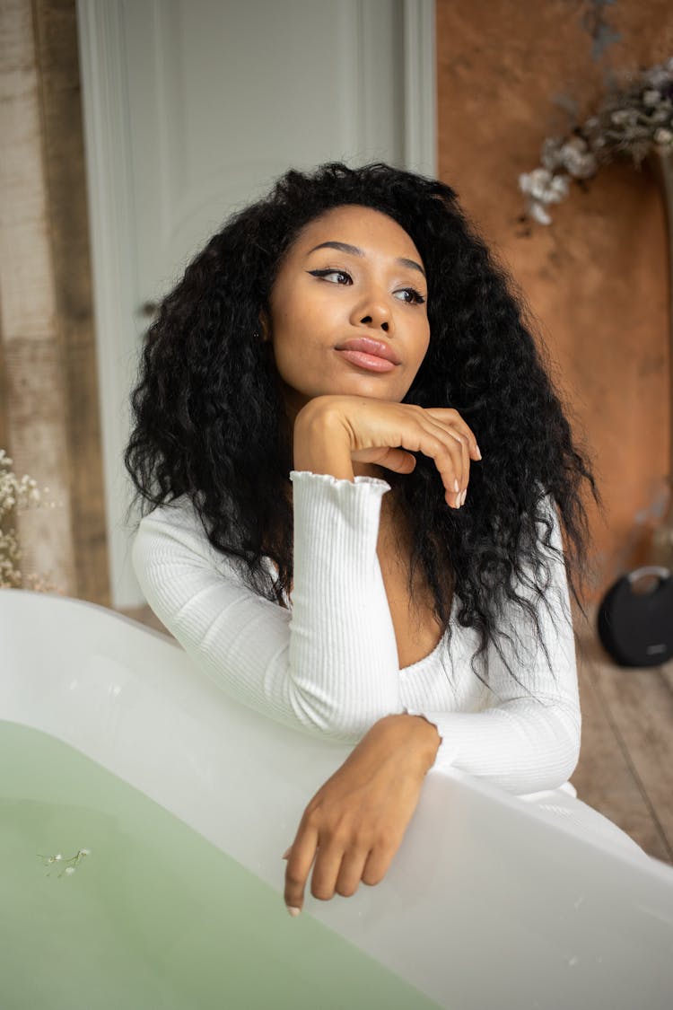 Black Woman Sitting Near Bathtub