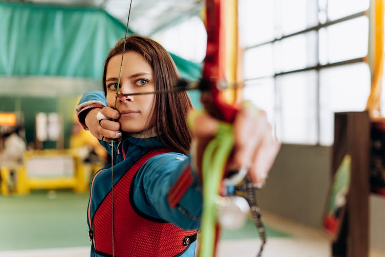 Beautiful Woman Shooting A Bow And Arrow