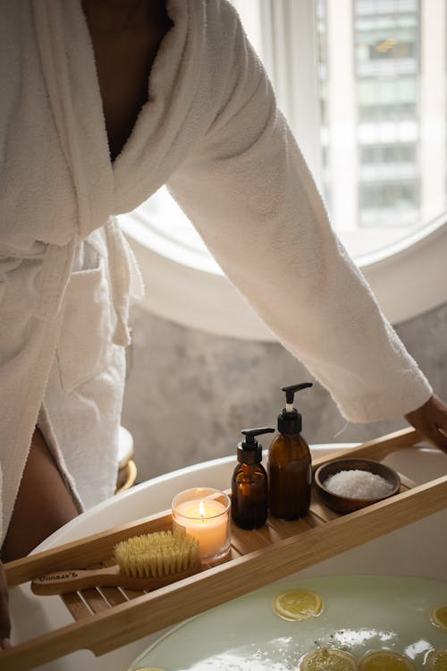 Crop woman with tray of spa products