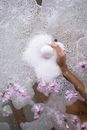 Crop woman sitting in foamy water