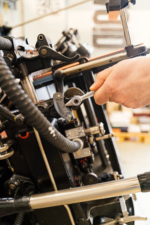 Close up of a Hand Pressing a Handle of a Machinery · Free Stock Photo